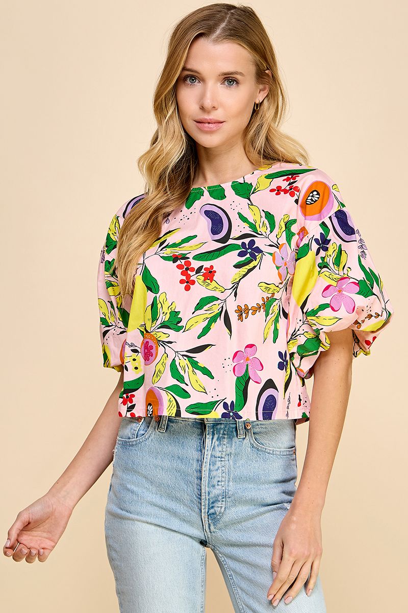 Introducing the Resort Cutie Top: a vibrant and playful addition to your wardrobe. This abstract printed top boasts short balloon sleeves and a flattering dropped shoulder design, perfect for any occasion. With a back keyhole and button closures, it's effortlessly stylish and easy to wear. Order yours today!