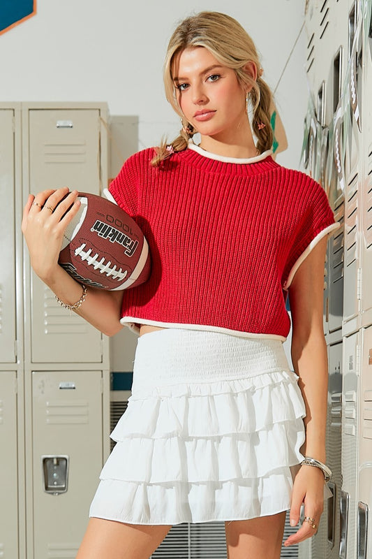 Score a fashion touchdown with the Go Team Top! This boxy sweater top not only scores high on style, but also offers a comfortable and relaxed fit. The contrast details add a playful twist to this must-have piece for all your game day looks. Go team!