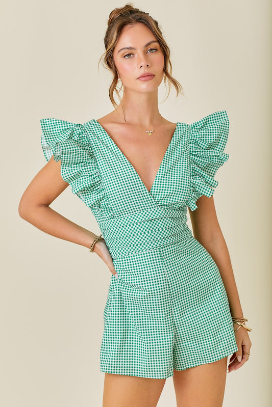 Get ready to play in the Vacay Time Romper! This V-neck gingham romper features playful ruffle sleeves for a fun and flirty touch. Perfect for your next vacation or weekend outing, it's a must-have for any wardrobe. Time to pack your bags and hit the road!