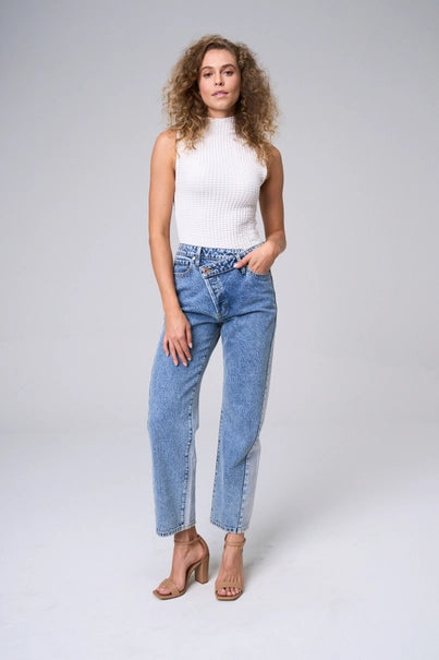 Elevate your wardrobe with The Brette Jeans. Experience the snug fit and high rise waist that flatters your figure. The unique criss-cross design adds a stylish touch, while the wide straight legs provide comfort and versatility. Make a statement with the light two-tone wash.