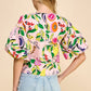 Introducing the Resort Cutie Top: a vibrant and playful addition to your wardrobe. This abstract printed top boasts short balloon sleeves and a flattering dropped shoulder design, perfect for any occasion. With a back keyhole and button closures, it's effortlessly stylish and easy to wear. Order yours today!