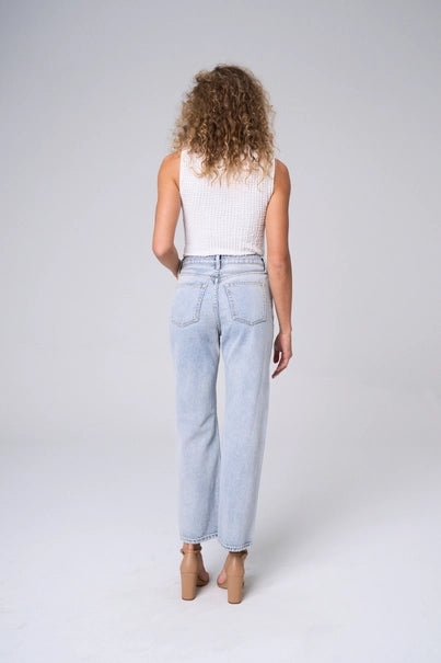 Elevate your wardrobe with The Brette Jeans. Experience the snug fit and high rise waist that flatters your figure. The unique criss-cross design adds a stylish touch, while the wide straight legs provide comfort and versatility. Make a statement with the light two-tone wash.